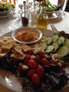 Food: Sampling a Mediterranean plate that includes hummus, Kalamata olives, cucumber, tomato, pita chips & crumbled Feta.