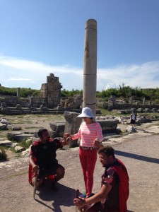 Roman soldiers get on their knees to greet a tourist at Perge.