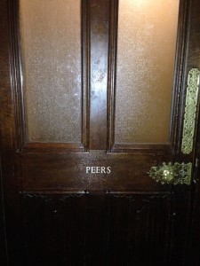 Respectfully and quietly entering the "Peers" toilet in the House of Lords.