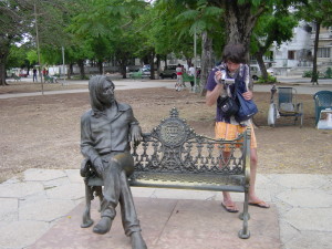 Sitting next to John Lennon in an Havana park.