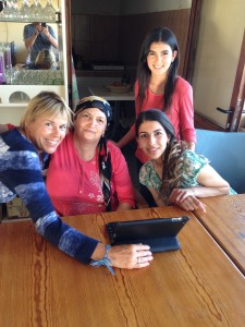 Liz shows photos to the female members of the Kurdish family who own the Dilara restaurant in Dipkarpaz.