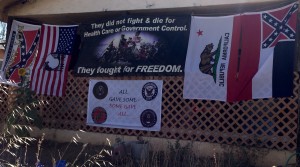 The script on one flag reads "Heritage Not Hate - Keep It Flying."