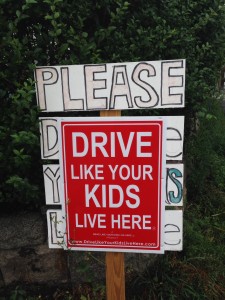 Smart signage in a children-filled hood near the Gloucester harbor.