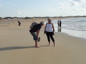 Israel: What, The Idiot wonders as he looks at this photograph with Michal Shor-Knipe, are the Orthodox women thinking about this encounter on the beach near Atlit, Israel?