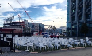 Artist's Statement "185 square metres of grass depicting new growth, regeneration. 185 painted white chairs, all painted twice by hand as an act of remembrance. This installation is temporary -- as is life."  Peter Majendie