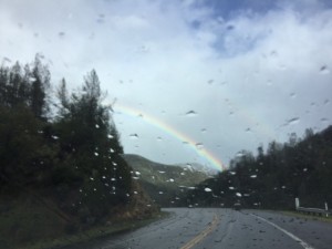 A rainbow appears through a rain-spotted windshield near the end of a three-hour drive across the Trinity Alps from Trinidad to Redding, CA. (Photo: Liz Chapin)