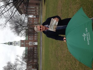 The Idiot with a copy of The Dartmouth, the oldest college newspaper in the US  founded in 1799, in front of the Baker-Berry Library  at Dartmouth College in Hanover, NH. (Photo: Liz Chapin)