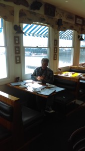 The Idiot writes notes about his trek south of Boston while waiting for a service of naked calamari at Jake's Seafood Restaurant in Hull, MA. (Photo: Liz Chapin)