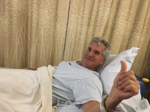 The Idiot gives paparazzi a thumbs up when he's rolled into the Stanford Hospital OR for a bilateral lumbar laminotomy. (Photo: Liz Chapin)