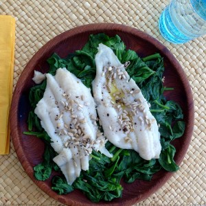 The Idiot prepares fillets of Dover sole on a bed of boiled spinach with virgin olive oil, pepper and organic hulled sunflower seeds.