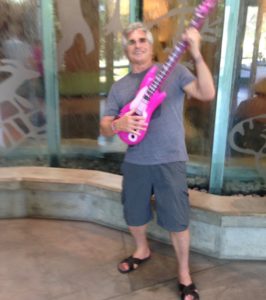 Dropping into the Turtle Bay museum to play a plastic guitar.