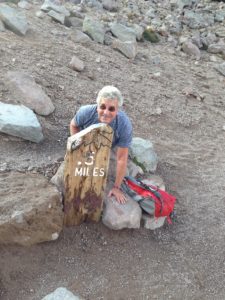 The Idiot does a few pushups at a sign indicating that he's half a mile from the peak of Mount Lassen. (Photo: Liz Chapin)