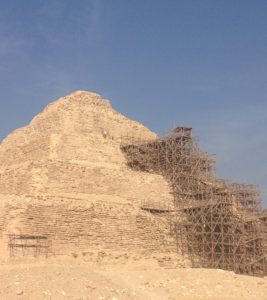 "Alexander the Great told me to tell you to quit trying to repair this pyramid!" The Idiot shouted to two workers at the top of the scaffolding in Saqqara.