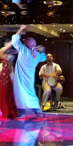 The Idiot dances with an Egyptian belly dancer on the Nile. (Photo: Kate Gale)