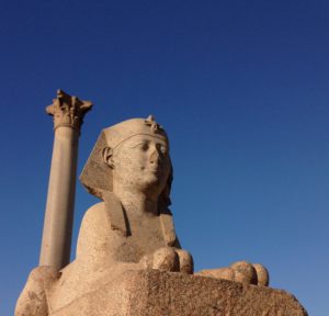 Can the Sphinx at Pompey's Pillar in Alexandria, Egypt, contribute to the heated and controversial discussion concerning Alexander's burial site?
