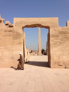 An Egyptian walking at the Karnak Temple complex.